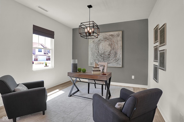 office with a chandelier, visible vents, light wood-type flooring, and baseboards