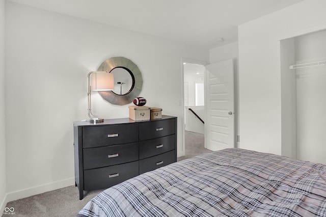 bedroom featuring light carpet and baseboards