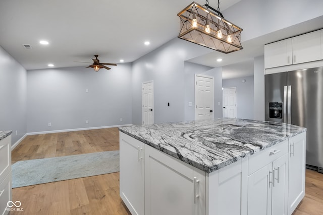 kitchen featuring visible vents, recessed lighting, stainless steel refrigerator with ice dispenser, and light wood-type flooring