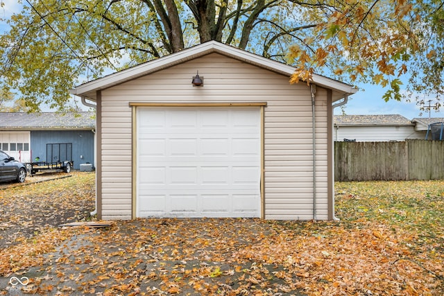 detached garage featuring fence