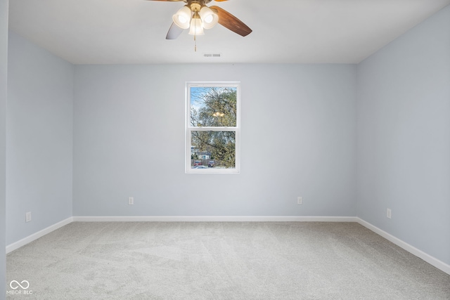 spare room with baseboards, carpet, and a ceiling fan