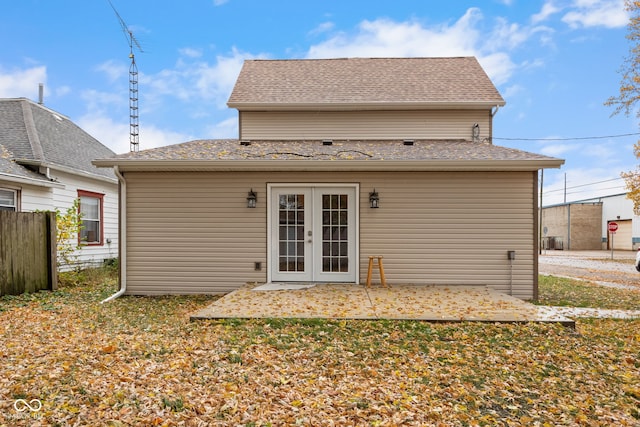 back of house featuring french doors, a patio area, roof with shingles, and fence