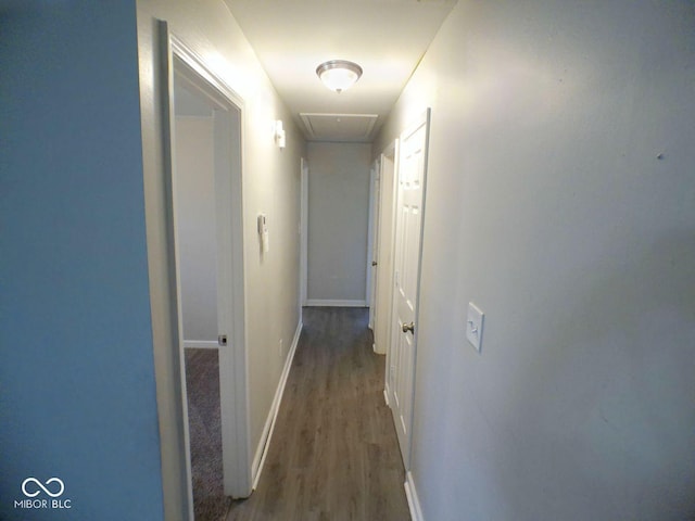 hall with wood finished floors and baseboards