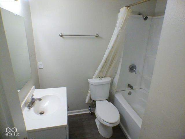 bathroom featuring vanity, toilet, wood finished floors, and shower / bath combo with shower curtain