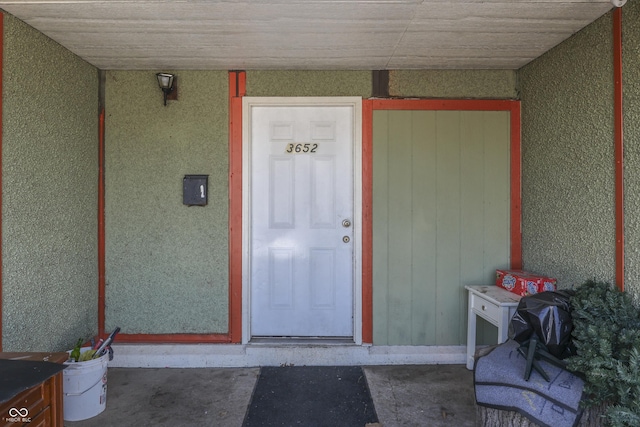 property entrance featuring stucco siding