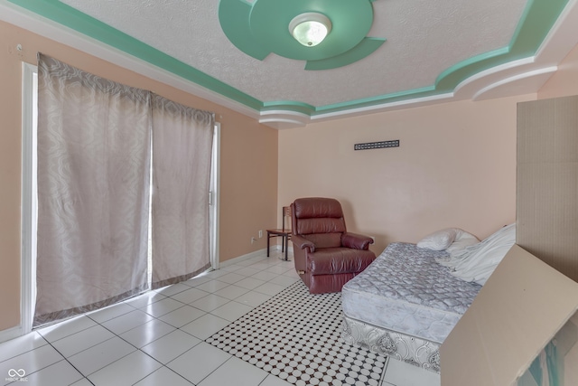 sitting room with tile patterned flooring, a raised ceiling, baseboards, and a textured ceiling