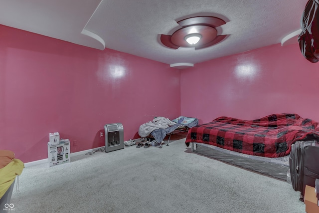 bedroom with heating unit, a textured ceiling, a ceiling fan, and carpet