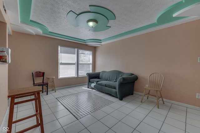 living area with light tile patterned floors, baseboards, and a textured ceiling