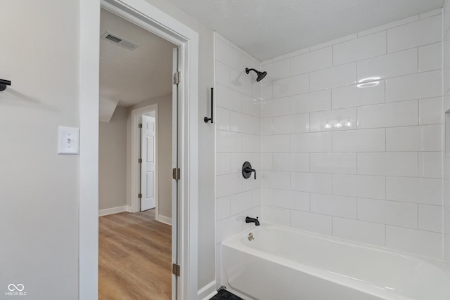 full bath featuring visible vents, shower / bathtub combination, baseboards, and wood finished floors