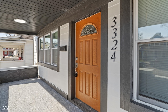 view of exterior entry featuring a porch