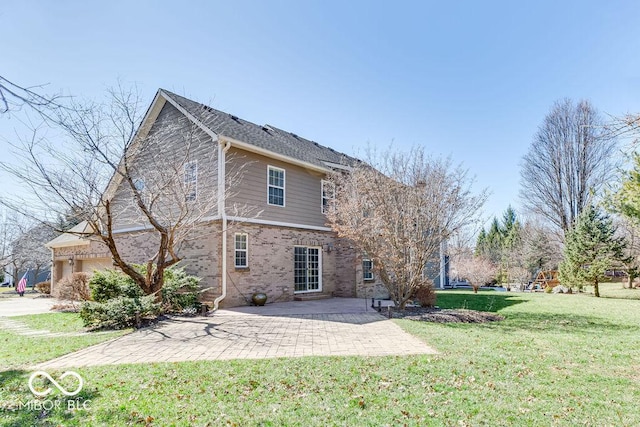 back of house featuring a patio area, a garage, a lawn, and brick siding