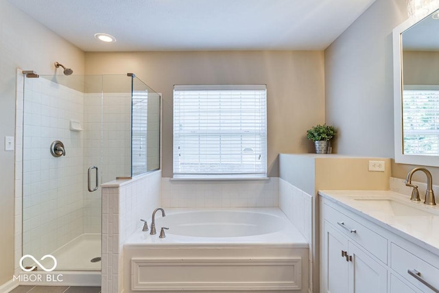 full bath featuring vanity, a bath, and a stall shower