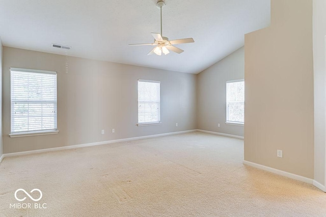 spare room with a ceiling fan, carpet, a healthy amount of sunlight, and visible vents