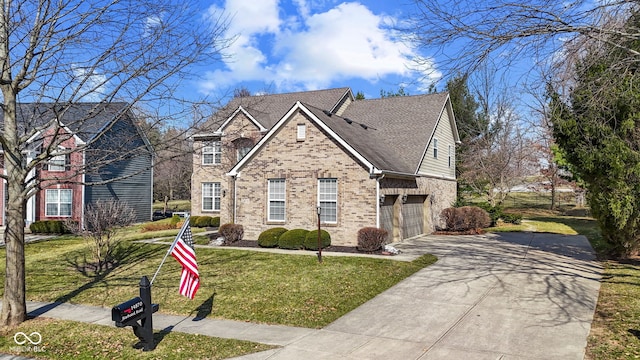 traditional-style house featuring driveway, a front yard, a shingled roof, a garage, and brick siding