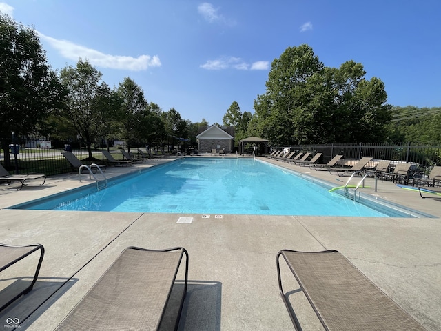 pool featuring a patio and fence