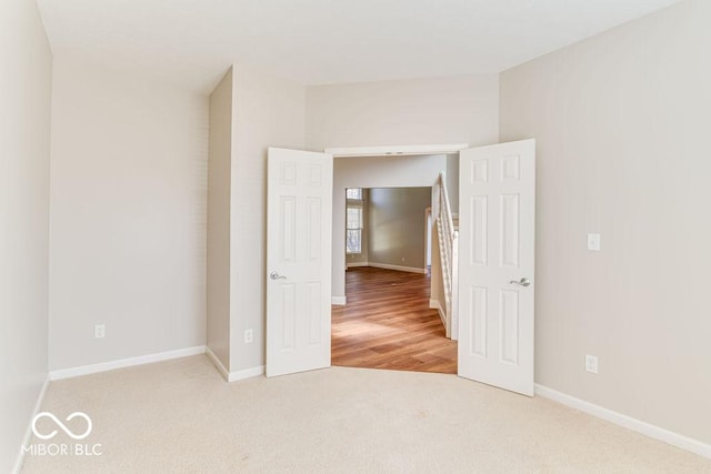 empty room with carpet flooring and baseboards