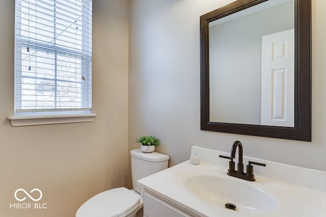 bathroom featuring toilet and vanity