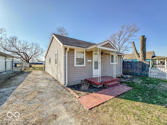 exterior space with covered porch, a front yard, and fence