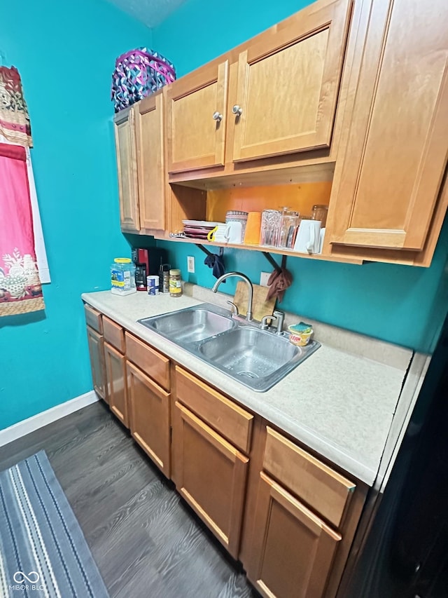 kitchen featuring a sink, open shelves, light countertops, baseboards, and dark wood-style flooring