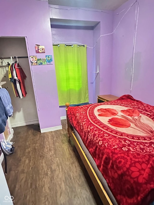 bedroom featuring baseboards and wood finished floors