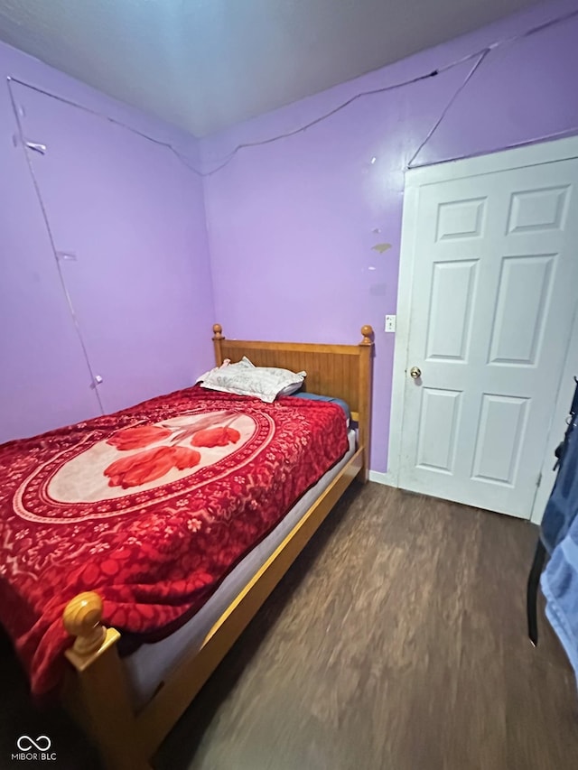 bedroom with dark wood finished floors