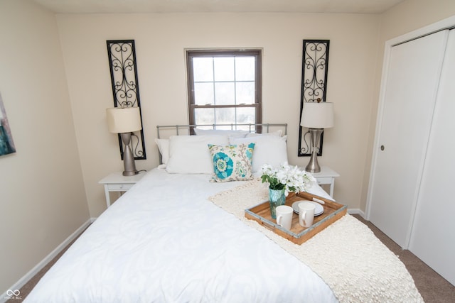 bedroom featuring baseboards and a closet