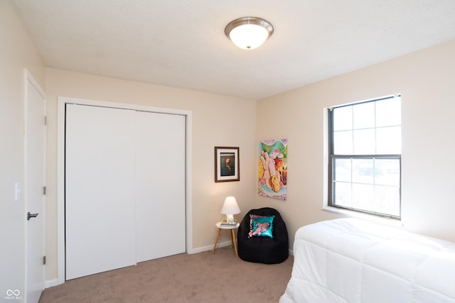 carpeted bedroom featuring a closet