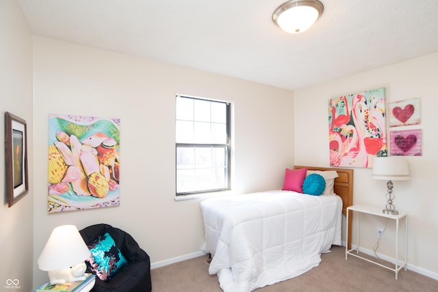 carpeted bedroom featuring baseboards