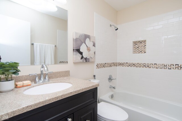 bathroom featuring vanity, toilet, and shower / washtub combination