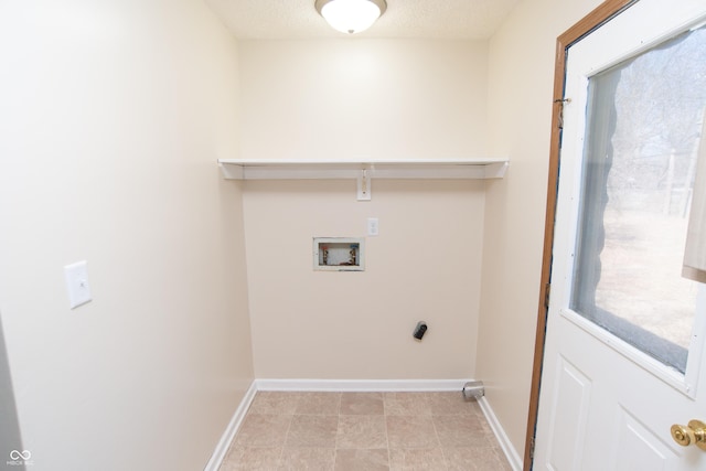 clothes washing area featuring laundry area, hookup for a washing machine, a textured ceiling, and baseboards