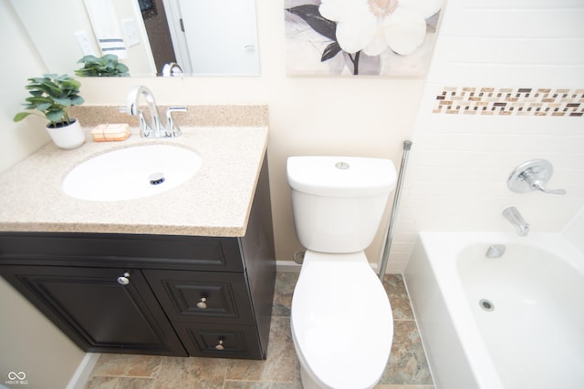 full bathroom with baseboards, toilet,  shower combination, and vanity