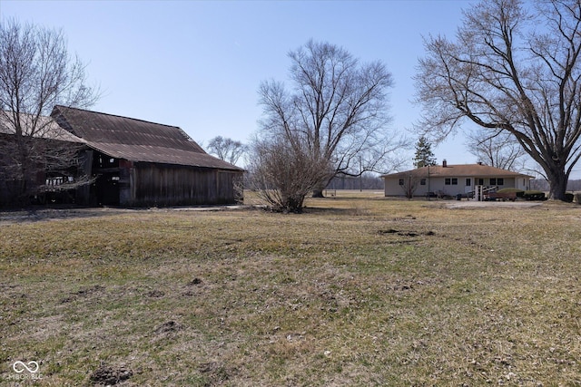 view of yard with an outbuilding and a barn