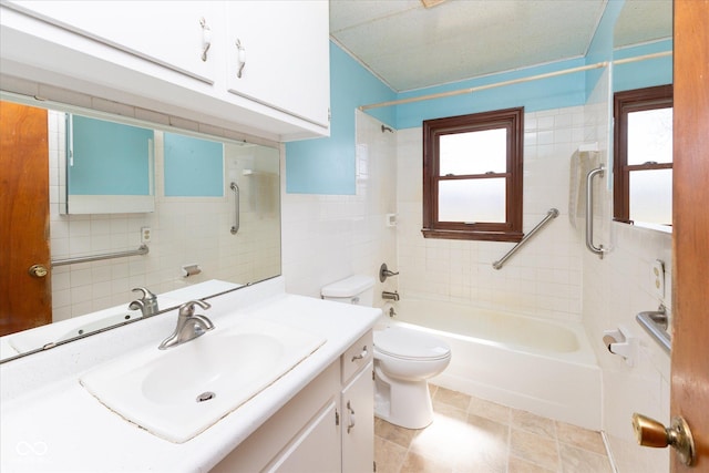 full bathroom featuring tub / shower combination, toilet, tile walls, and vanity