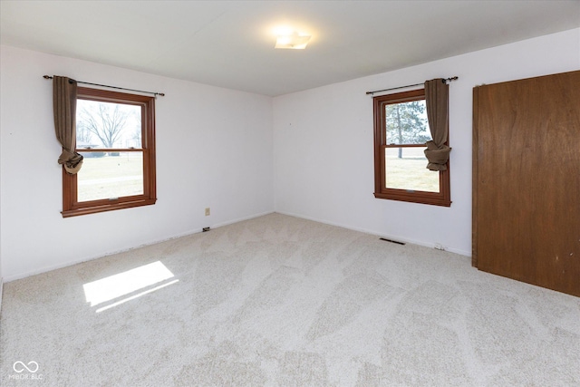 empty room with visible vents and carpet floors