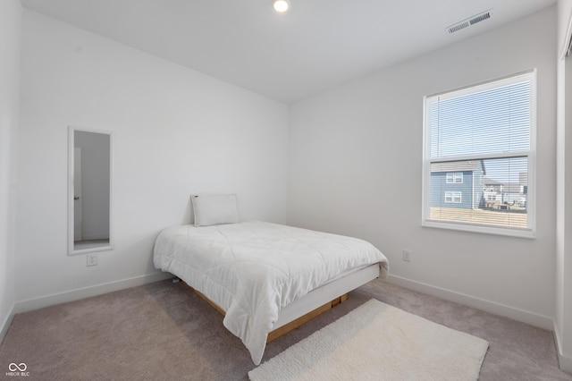 bedroom featuring visible vents, baseboards, and carpet flooring