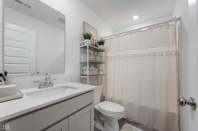 bathroom featuring vanity, toilet, shower / bath combo, and visible vents