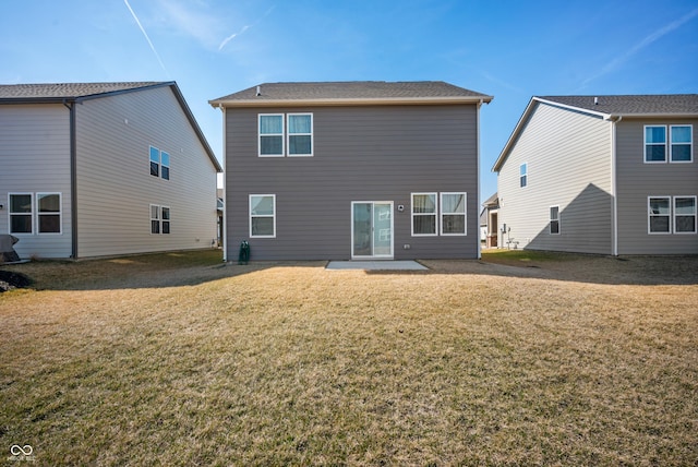 rear view of property with a patio and a lawn