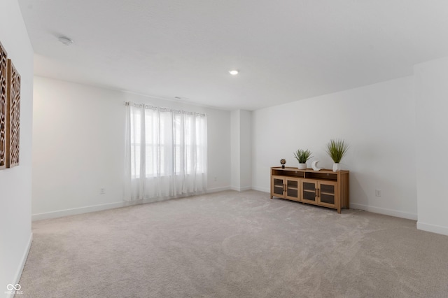 unfurnished room featuring recessed lighting, baseboards, and carpet flooring