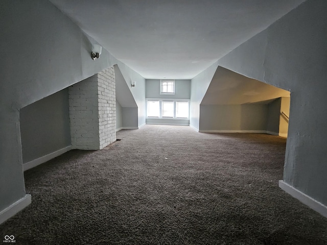 bonus room featuring baseboards and carpet floors