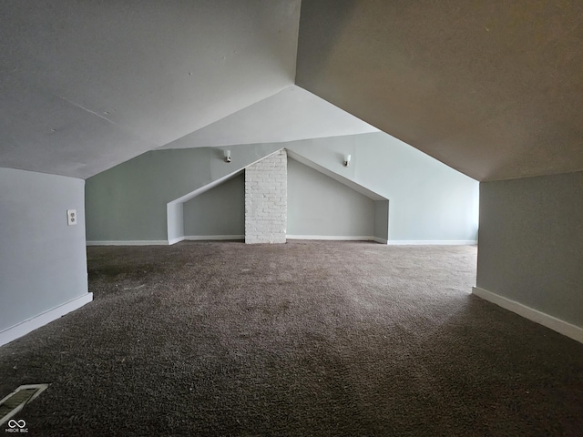 bonus room featuring baseboards, lofted ceiling, and carpet flooring