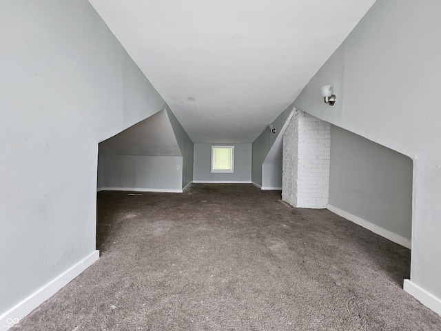 additional living space featuring baseboards and carpet floors