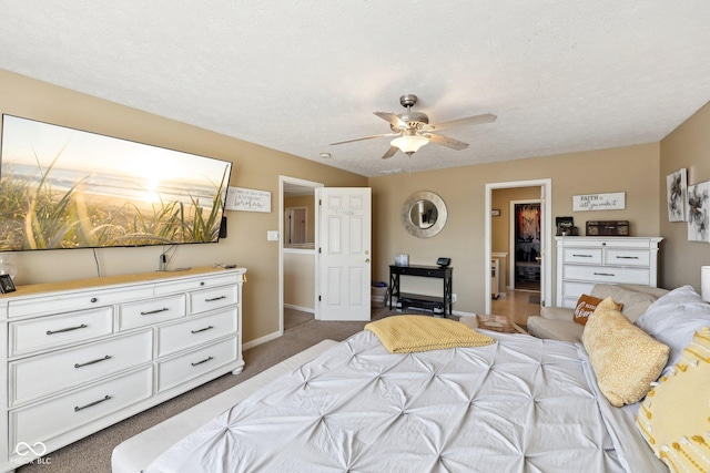 carpeted bedroom with baseboards, a textured ceiling, and a ceiling fan