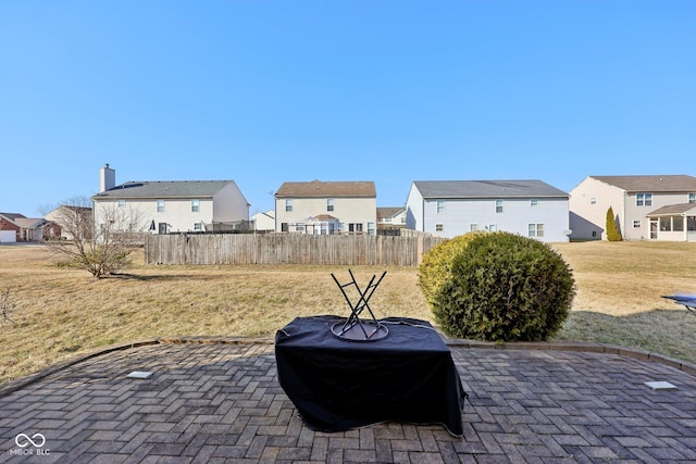 view of patio / terrace featuring fence and a residential view