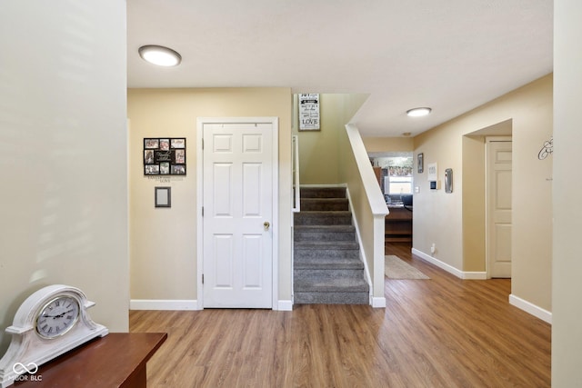 stairs featuring baseboards and wood finished floors