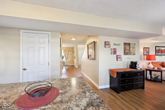 interior space featuring baseboards and wood finished floors