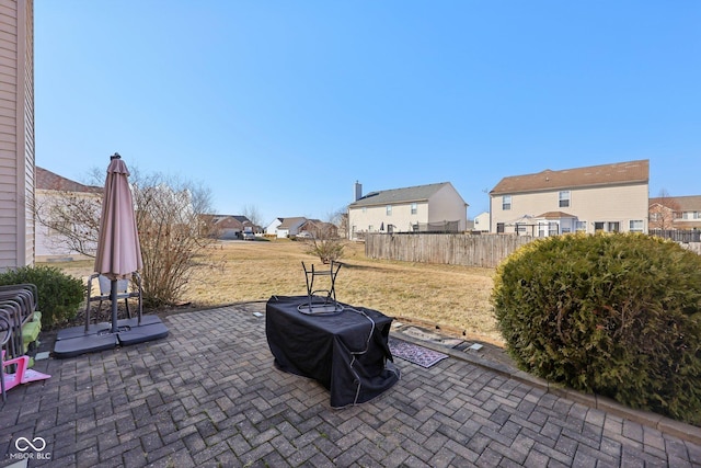 view of patio with a residential view and fence