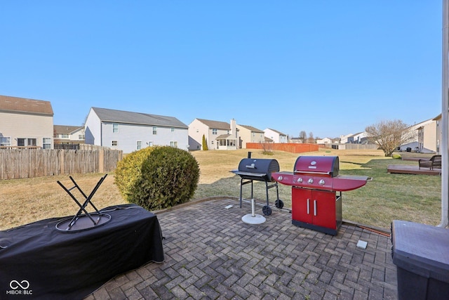 view of patio with a residential view, a grill, and fence