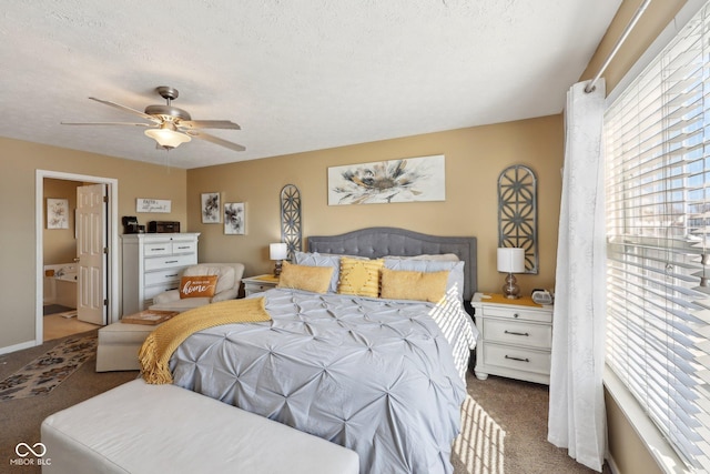 bedroom with carpet flooring, a textured ceiling, ensuite bathroom, and ceiling fan