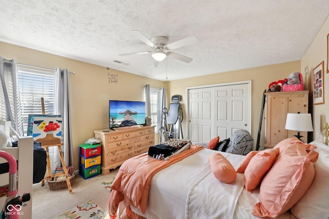 bedroom with a closet, multiple windows, carpet, and ceiling fan