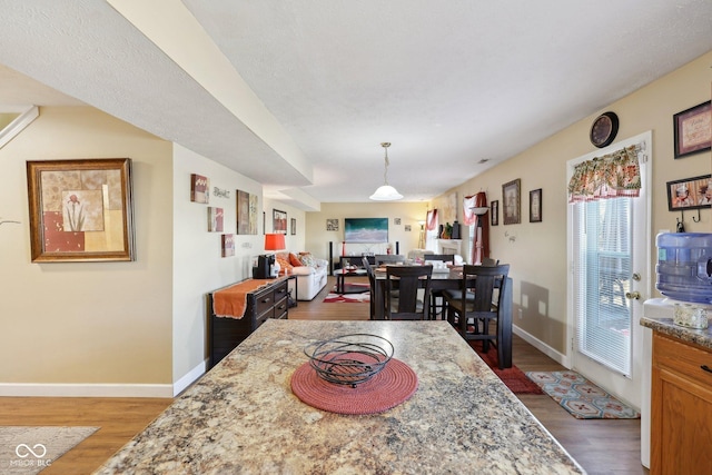 dining space featuring baseboards and dark wood-type flooring